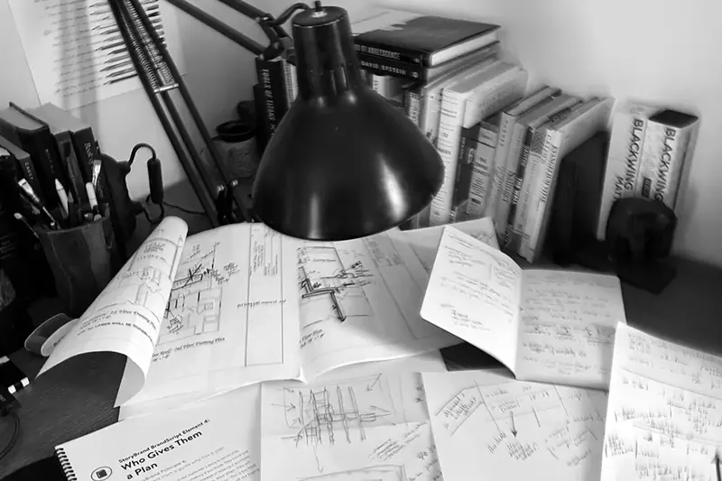 Sketches, notebooks, books and pencils on Micah’s desk